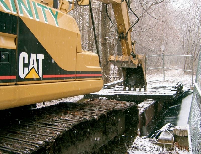 050105CRTBridgeDeck1 So on a snowy January day in 2005, heavy equipment carefully removes the heavy debris.