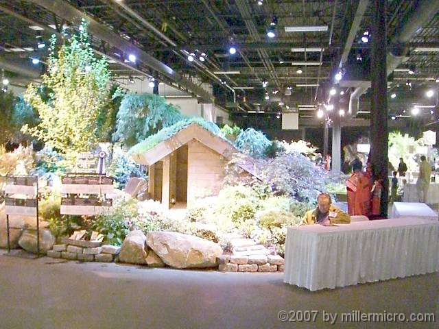 070323FlowerShow652 Another large exhibit features a sod-roofed Adirondack lean-to, looking out upon another pond.