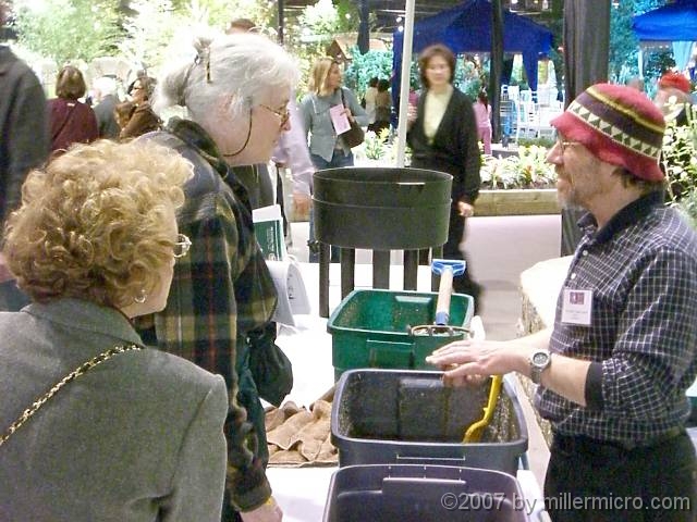 070323FlowerShow733 Jill and The Worm Guy exchange composting tips.