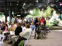 070323FlowerShow737 Folks stop to hear a talk.